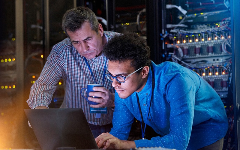 IT Techs Working in a Dark Server Room