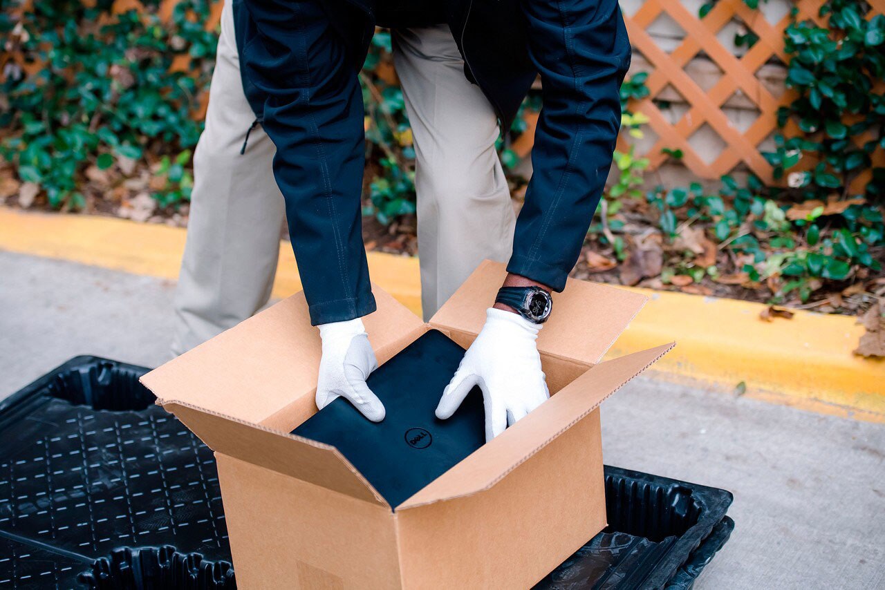 Asset Recovery Services - Man Packing Laptop Into Box