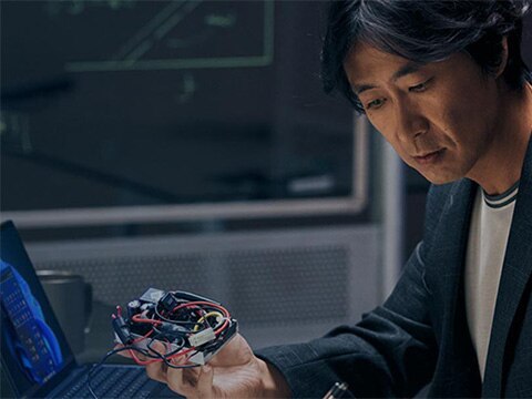 Image 73: Image of a man working with laptop and gadgets from the What We Do campaign.