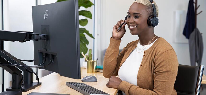 Woman Working on Computer with Headset