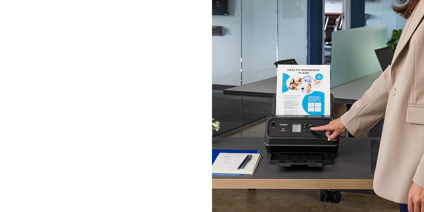Canon DR-C340 Scanner on desk with woman starting scan
