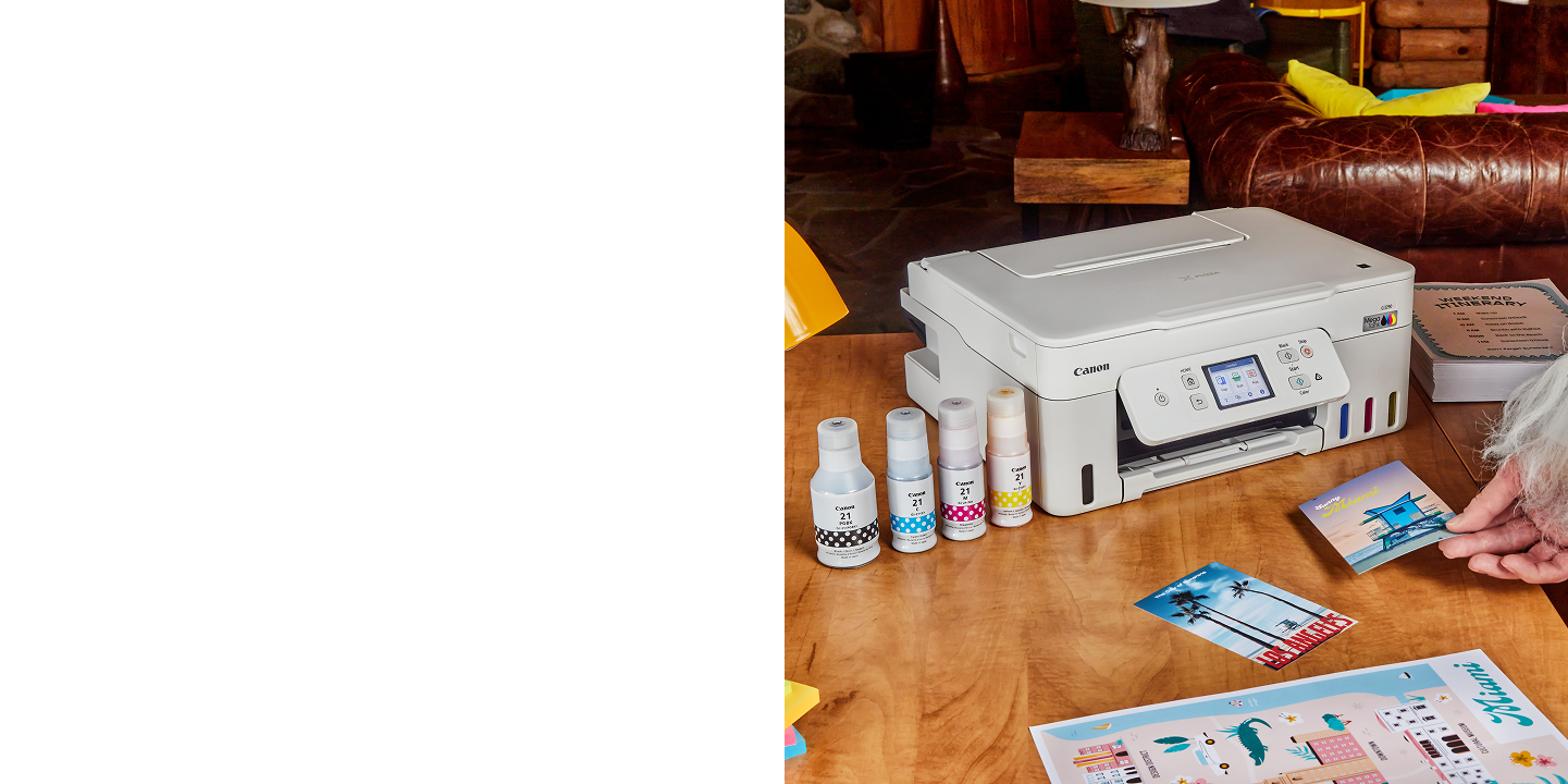 Canon G3290 printer on desk with ink and printed photos