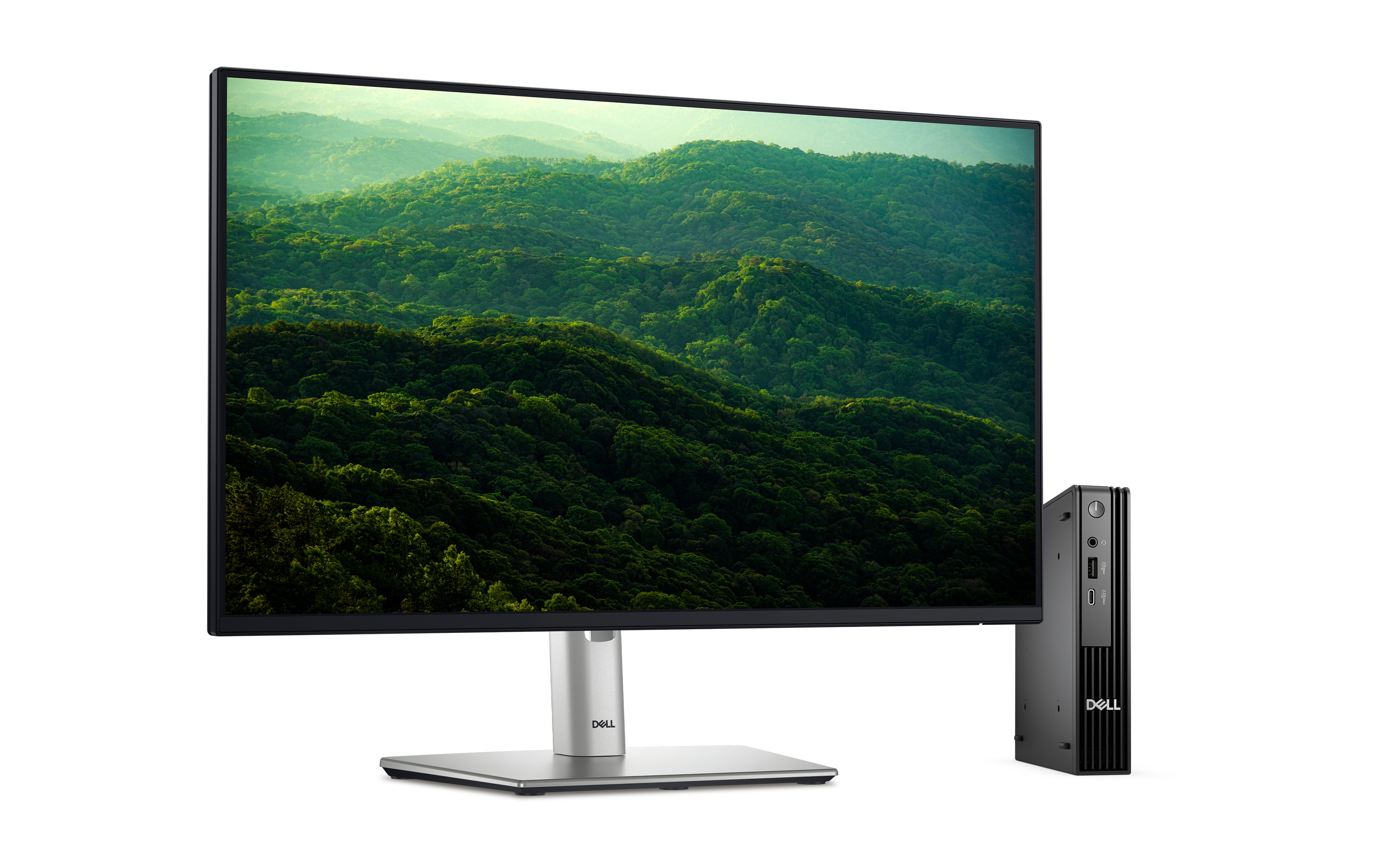  Dell Pro Micro next to Dell Monitor p2425h on white background. Screenfill of rolling hills filled with green trees.