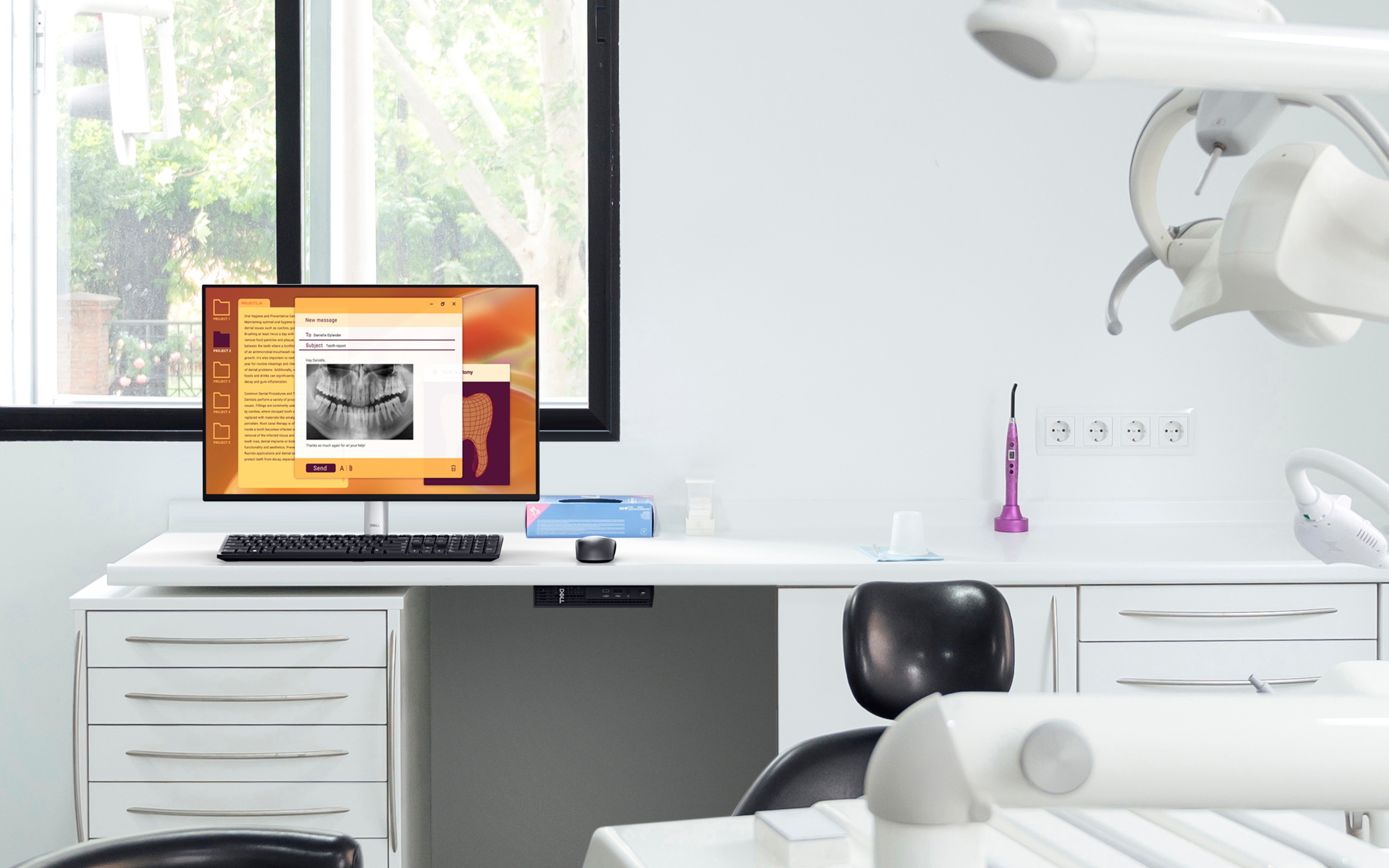 Dentist office with equipment and chair. Monitor and keyboard on desk with desktop mounted under desk.