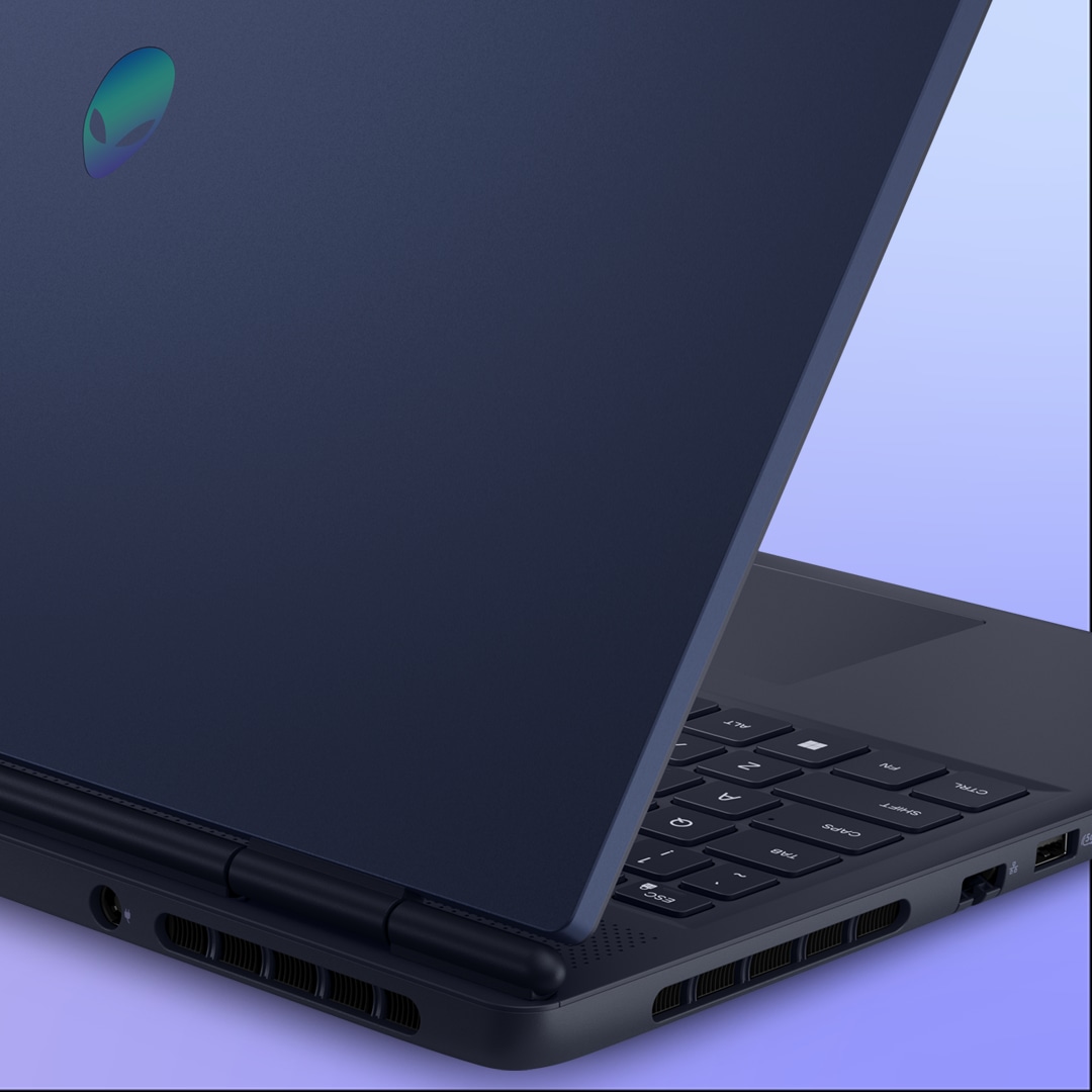 Two Alienware Aurora gaming laptops side by side, highlighting the Interstellar Indigo finish of the laptop’s chassis.