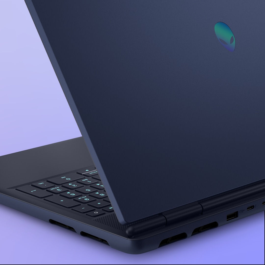 Two Alienware Aurora gaming laptops side by side, highlighting the Interstellar Indigo finish of the laptop’s chassis.