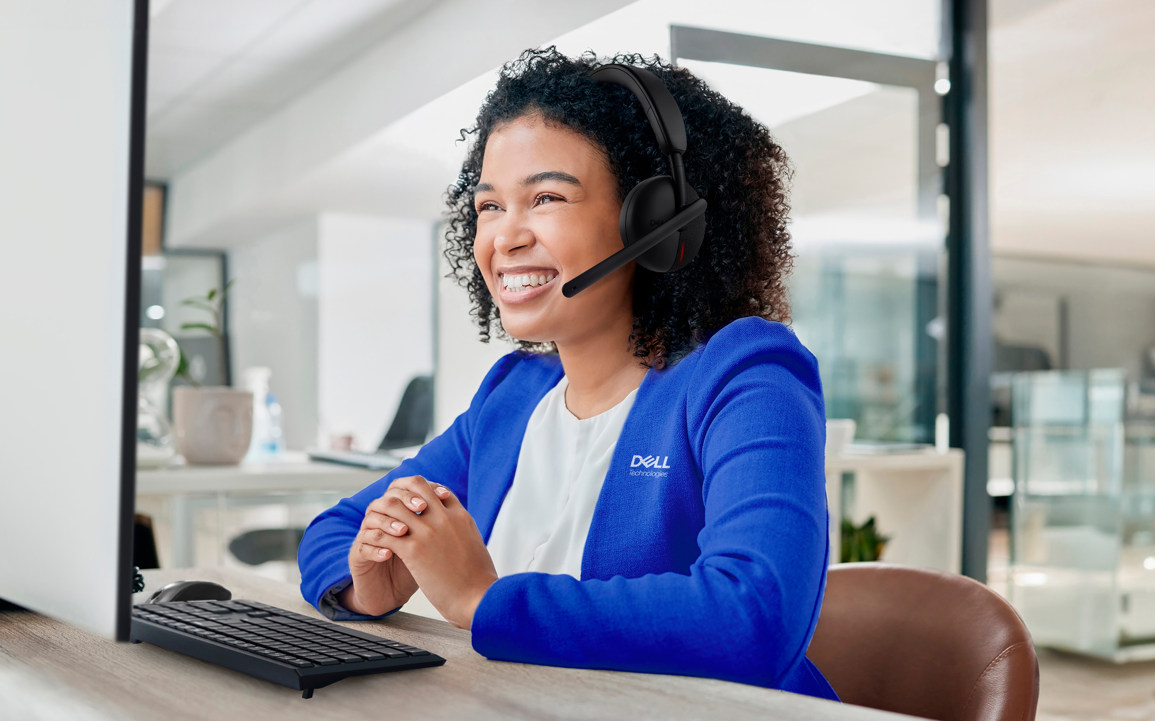 Black woman in a call center, phone call with customer service or telemarketing.
