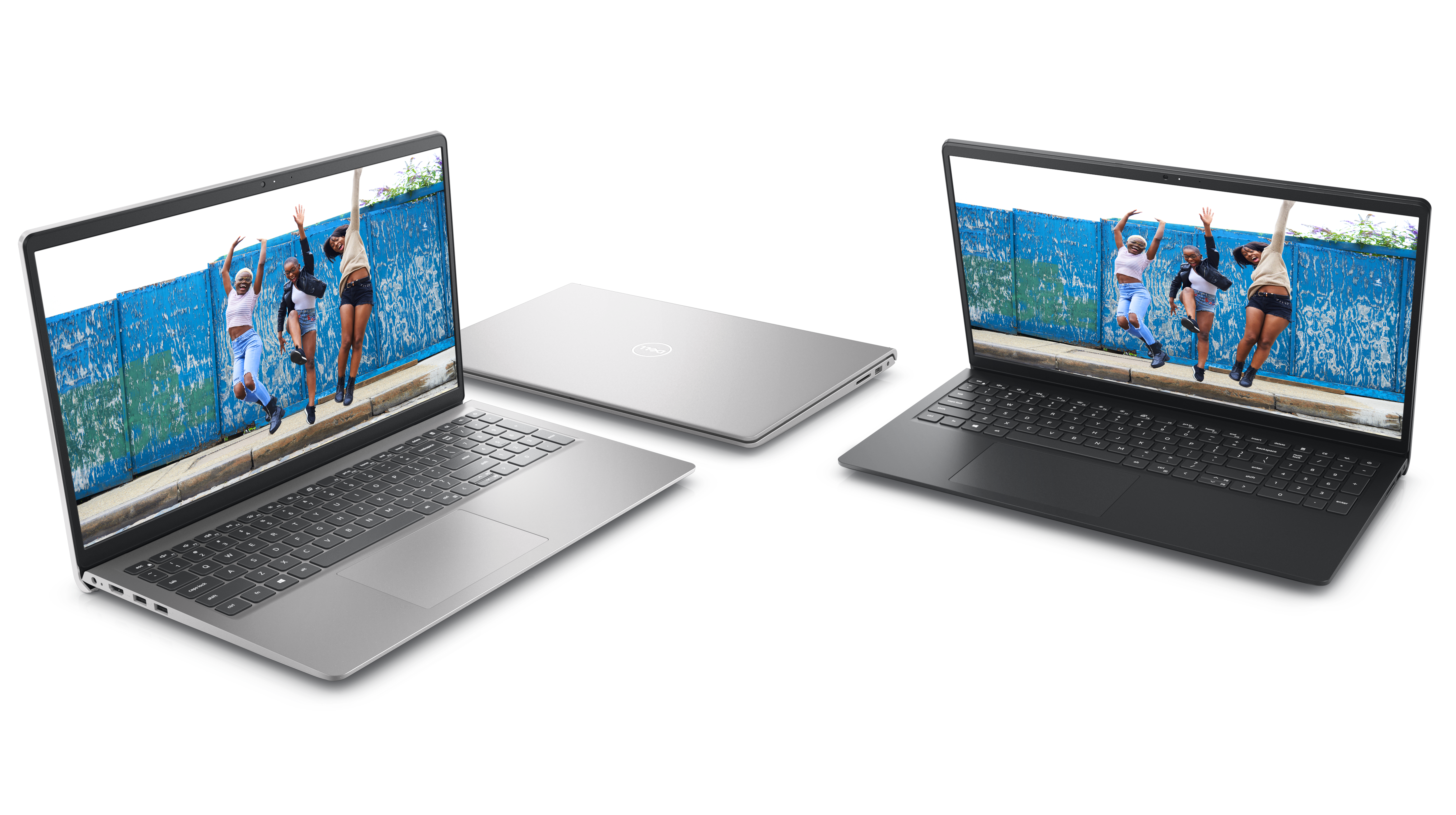 Bild mit vier nebeneinander platzierten Dell Laptops vom Typ Inspiron 15 3520, von denen zwei geöffnet und eins geschlossen sind.