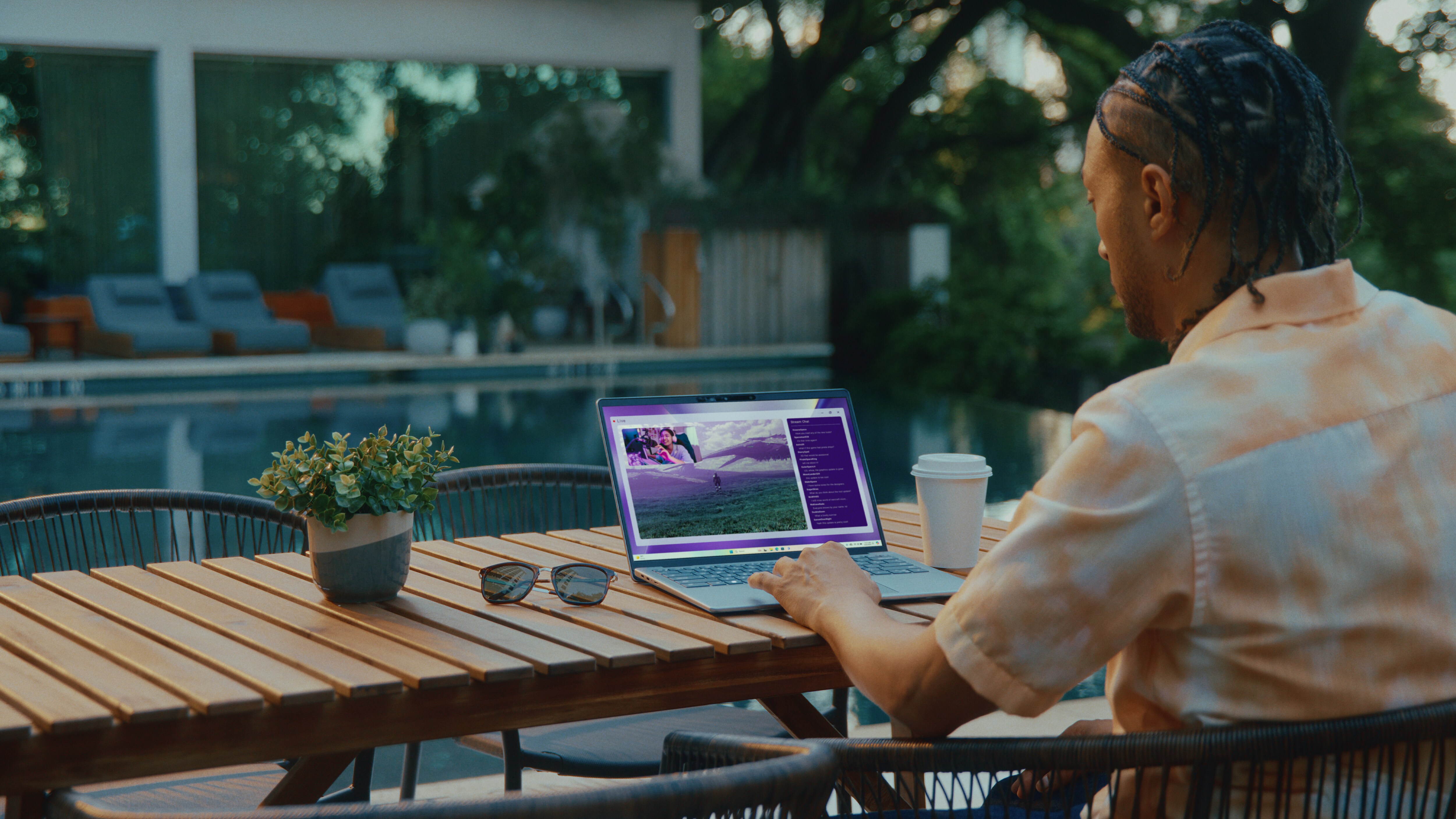Person using an Inspiron laptop outdoors. 