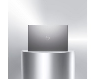 Picture of a Dell Vostro 15 3520 Laptop above a metallic object showing the back of the product with the Dell logo.