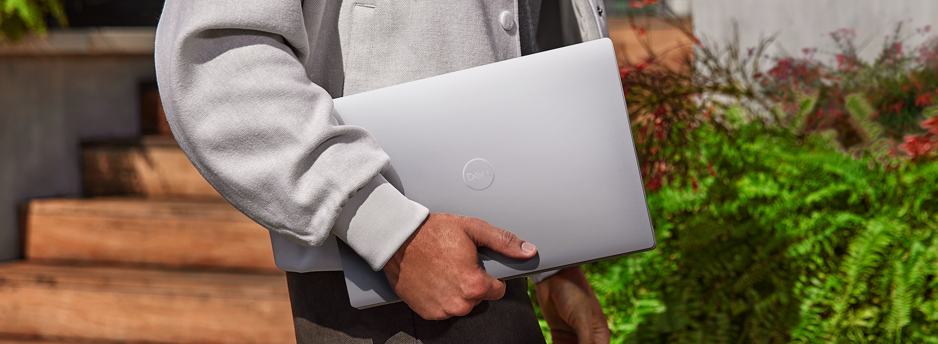 Male hands holding a Dell XPS 13 9340 Laptop.
