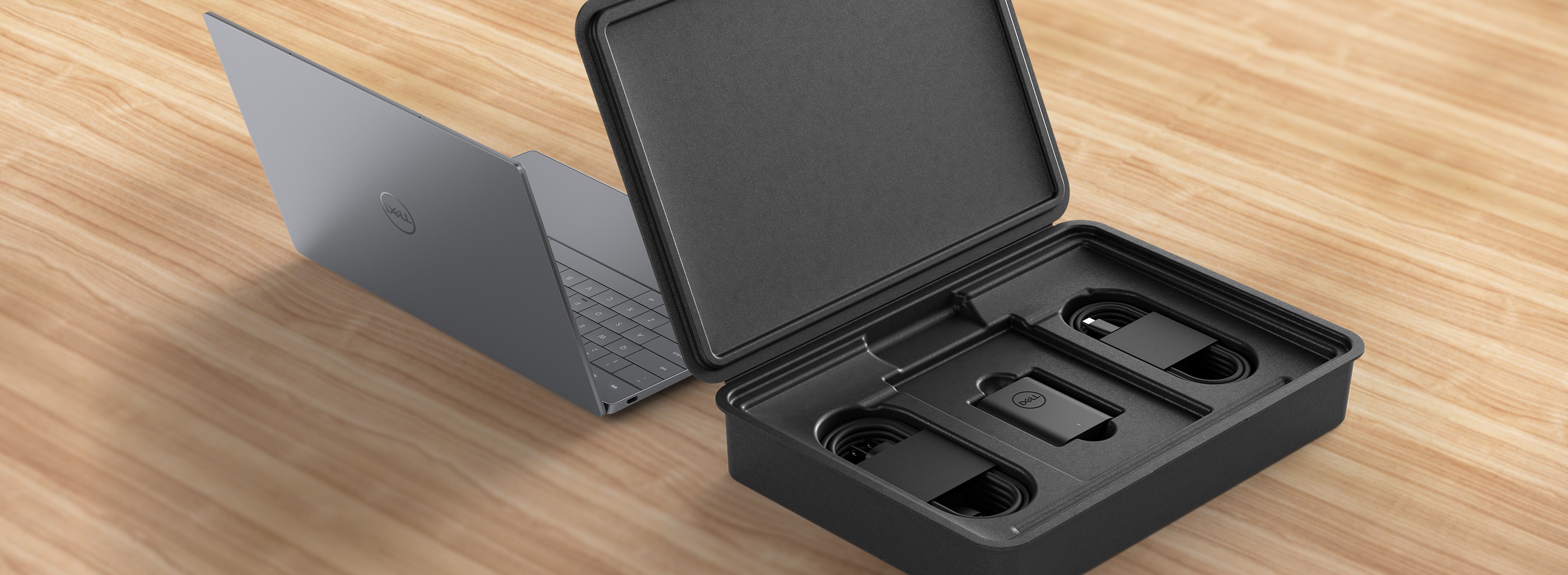 An open XPS laptop beside the packaging it comes in.