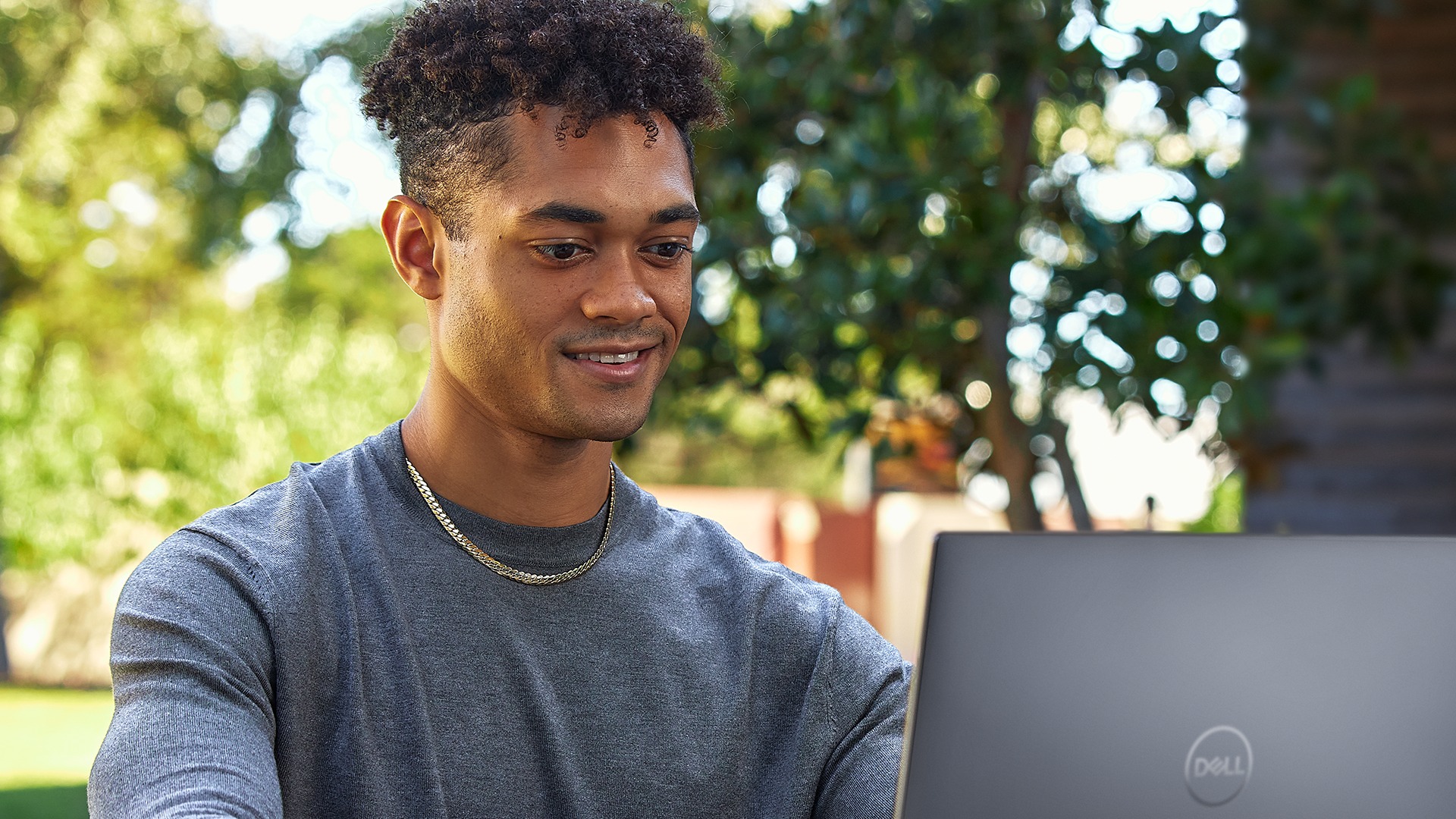 Smiling man using a Dell XPS Laptop