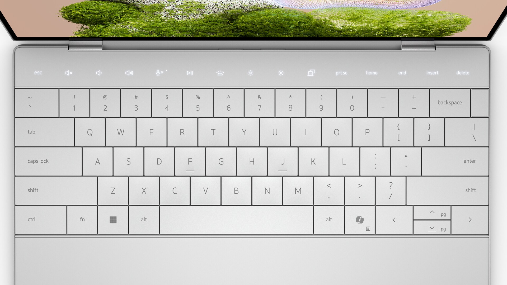 Top-down shot of a laptop keyboard. Highlight different touchpad features.