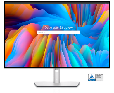 Picture of Dell U3023E Monitor with a colorful landscape, a search bar and “Developer Directory” written on the screen.
