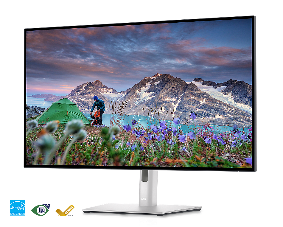 Abbildung des Monitors Dell U3223QE auf einem hellgrauen Hintergrund mit einer Landschaft auf dem Bildschirm.