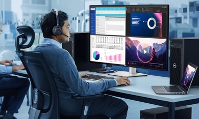 Mężczyzna siedzący na fotelu biurowym, piszący na klawiaturze i patrzący na monitor Dell UltraSharp U4323QE.