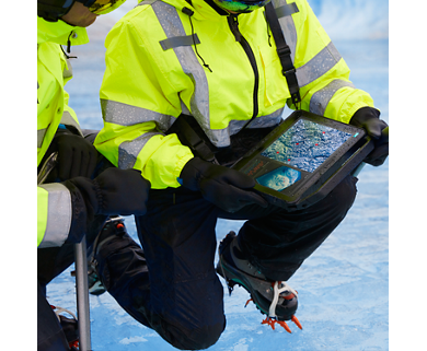 Men kneeling on ice in winter uniforms and holding a Dell Latitude 12 7230 tablet