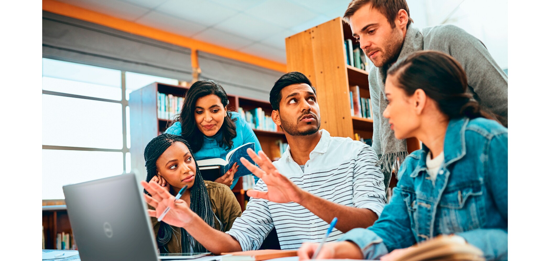 Image of a group of students collaborating on a Dell laptop