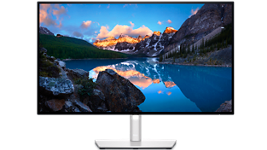 صورة لشاشة طراز Ultrasharp U2722D من Dell تعرض منظرًا طبيعيًا في الخلفية.