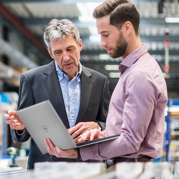 Businessmen using a Laptop in a Production Hall