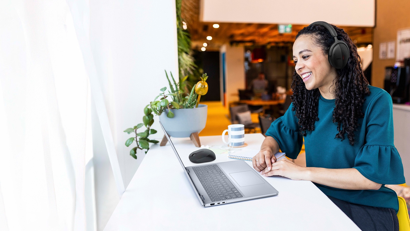 Happy businesswoman working from cafe.
